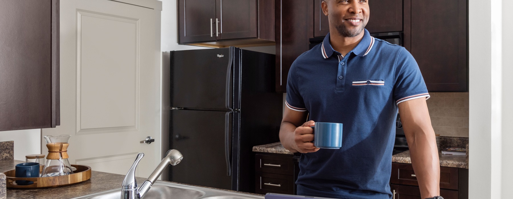 man drinking coffee in kitchen