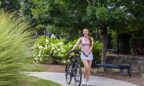 woman walking bike