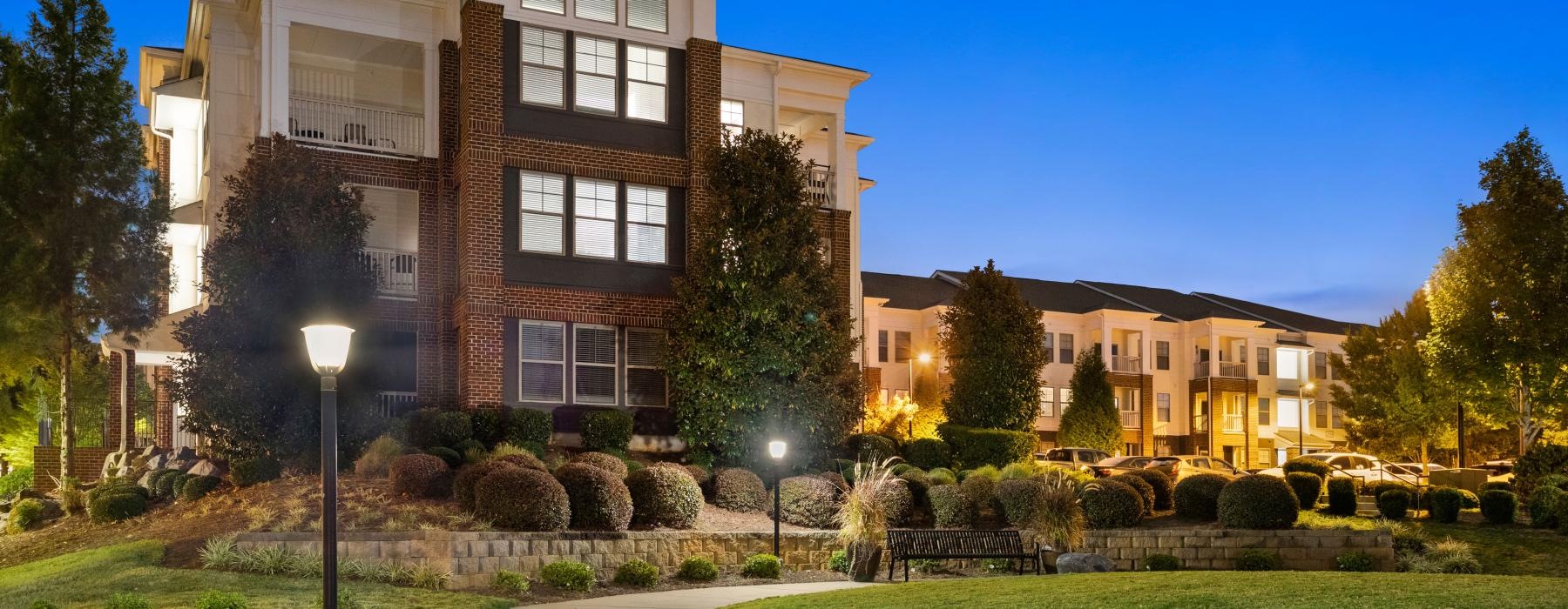 a building with a lawn and trees