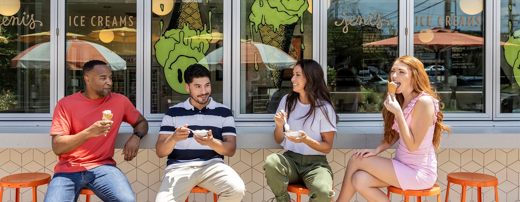 four people sitting outside eating ice cream