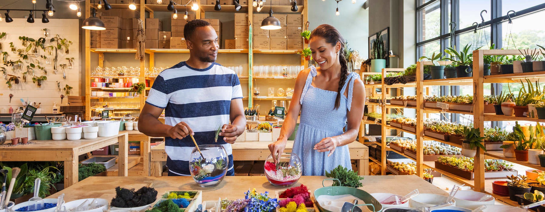 a couple making terrariums in a plant shop