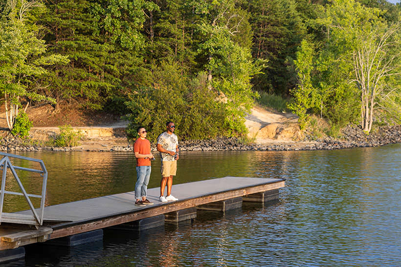 two people fishing off a pier